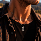 Silver-tone White Tree of Gondor-inspired pendant worn over a black shirt at sunset.