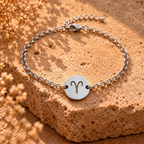 Silver chain bracelet with round zodiac charm showing Aries symbol