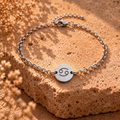 Silver-tone cancer awareness bracelet with round smiley face charm and link chain