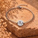 Silver chain bracelet with round Scorpio charm marked 'M'