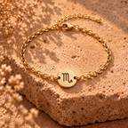 Gold chain bracelet with round Scorpio charm marked 'M'